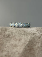 PAIGEAVERI white gold hinged eternity ring with brilliant-cut diamonds, featuring a unique clamshell opening for a secure fit.