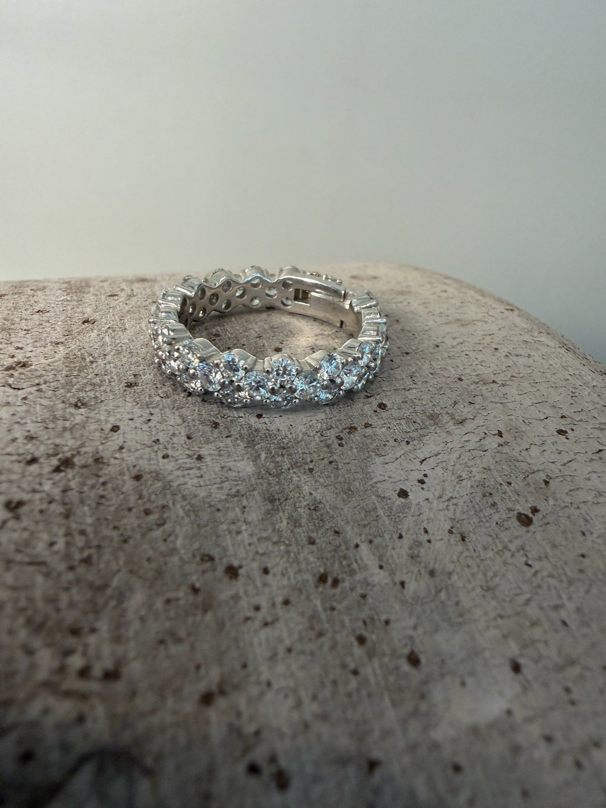 PAIGEAVERI white gold hinged eternity ring with brilliant-cut diamonds, featuring a unique opening for a custom fit.